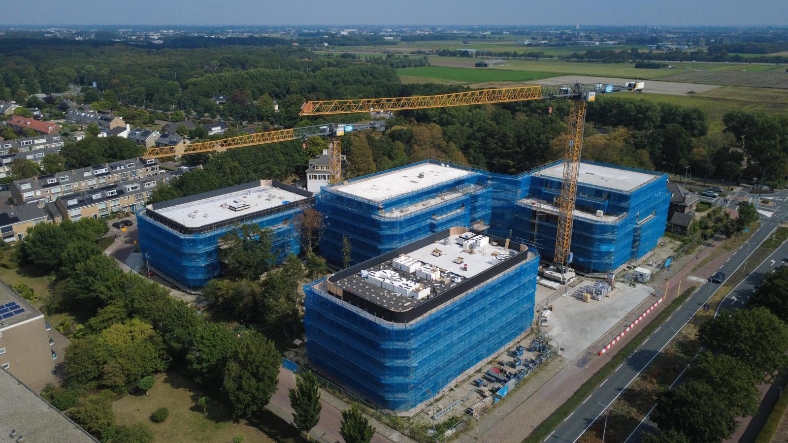 Luchtfoto van nieuwe gebouwen op de plaats van het Achmea gebouw