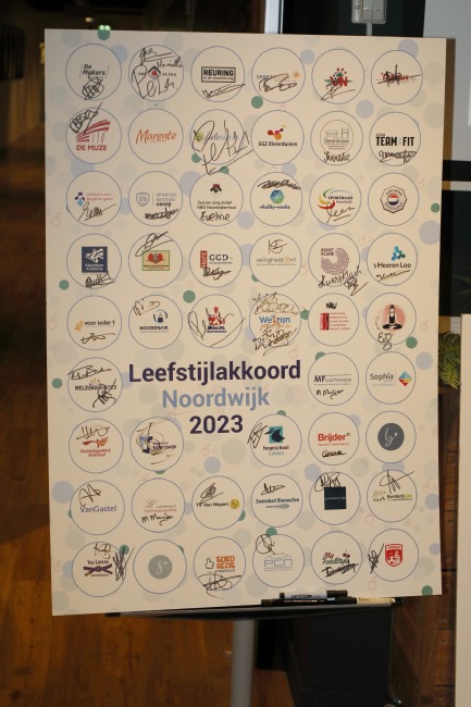 Bord met logo's en handtekeningen van alle partners die meedoen met het Leefstijlakkoord. 