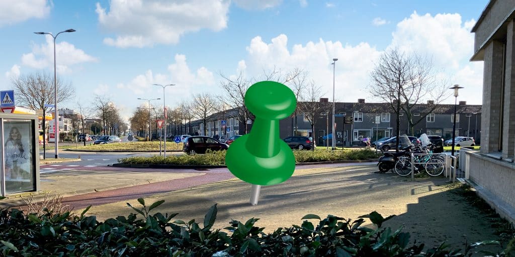 Groene punaise geprikt op de stoep als plek waar een boom zou kunnen staan