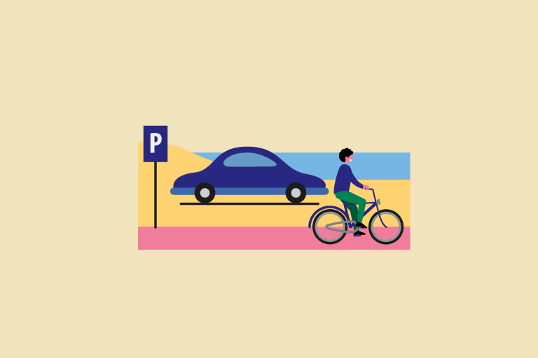 Auto naast een parkeerbord en een fietser